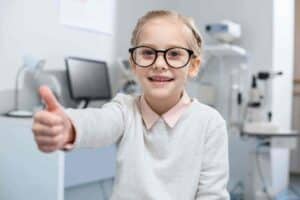 smiling-little-child-in-eyeglasses-showing-thumb-u-2022-05-08-23-19-13-utc_11zon-1787179